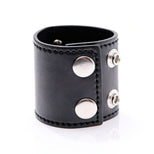 Side angle view of black 2-inch ball stretcher featuring dual snap closure and metal D-ring hardware
