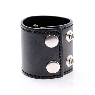Side angle view of black 2-inch ball stretcher featuring dual snap closure and metal D-ring hardware
