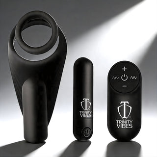 Black silicone c-ring with vibrating taint stimulator shown with bullet vibrator and remote control for hands-free stimulation