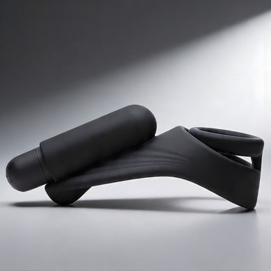 Side view of black silicone c-ring with curved arm and attached bullet vibrator designed for targeted stimulation