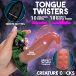 Promotional graphic for Creature Cocks Tongue Twisters, showing a hand holding a green marbled silicone tongue-shaped toy, with text highlighting 10 vibrating modes, 10 rotating tongue modes, remote control, dual motors, and a textured tongue detail on a purple background.
