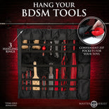 Black multi-tool hanging organizer with multiple zip pockets and three hanging rings, shown against a dark red brick background with text reading 'HANG YOUR BDSM TOOLS' and feature callouts.