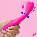 A hand holds a bright pink personal massager with a dual-lobed clitoral stimulator head. The image includes graphic overlays showing vibration and arousal, with a 'BANG!' text badge in the bottom right corner.