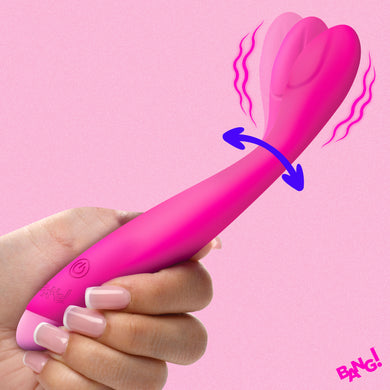 A hand holds a bright pink personal massager with a dual-lobed clitoral stimulator head. The image includes graphic overlays showing vibration and arousal, with a 'BANG!' text badge in the bottom right corner.