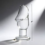 Clear glass penis-shaped butt plug with 5 inch length and 1.5 inch width measurement shown for size reference