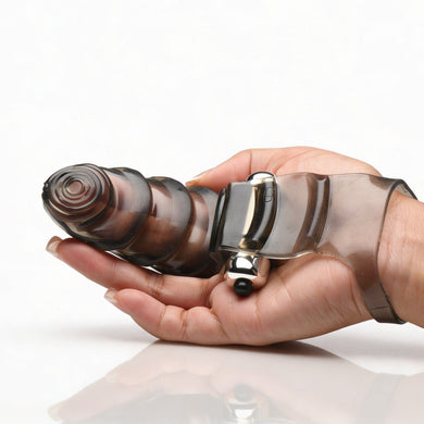 Hand holding the smoke gray vibrating finger glove to demonstrate size, shape, and ergonomic finger-worn design