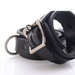 Close-up view of the adjustable metal buckle and reinforced construction on a black locking ankle restraint cuff