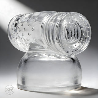 Clear textured sleeve attachment with internal ridges and flexible opening, designed to fit over wand massager heads for enhanced sensation