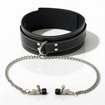 Black faux leather bondage collar with attached silver chain and adjustable nipple clamps displayed on a white background