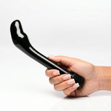 Hand holding The Essential P-Spot Vibe featuring a curved prostate-targeting design, smooth black finish, and easy-to-use control dial