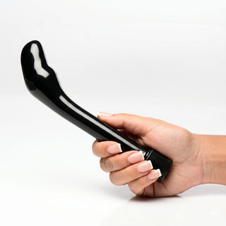 Hand holding The Essential P-Spot Vibe featuring a curved prostate-targeting design, smooth black finish, and easy-to-use control dial