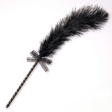 Black feather tickler with a striped handle and decorative ribbon, designed for light sensation play and intimate teasing.