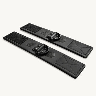 Leather Ankle Cuffs pair with steel D-rings and stitched Velcro panels, angled view, Fort Troff