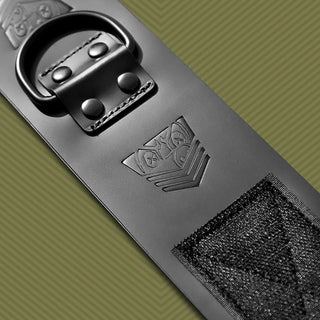 Leather Ankle Cuff macro detail of riveted D-ring, embossed logo and velcro closure, Fort Troff