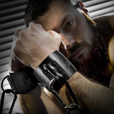 Leather Wrist Cuffs with steel D-rings and carabiner chain on a bearded model, Fort Troff