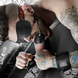 Masked model locked into Neo neoprene wrist restraints, Fort Troff