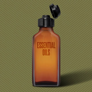 Pig Snout Flip cap opened on an amber essential oils bottle, olive background, Fort Troff