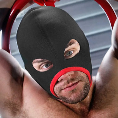 Bearded man with arms up in the red-trim Skullfuck open-mouth neoprene bondage hood, Fort Troff