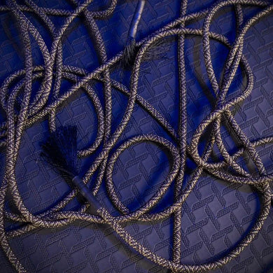 Grunt Rope bondage rope loosely looped on the floor with frayed tassel end