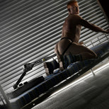 Gunner System fucking machine with a model on all fours backing onto the arm-mounted dildo