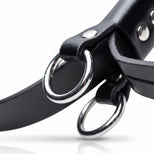 Close-up of reinforced metal attachment rings mounted on black bondage cuff straps