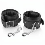 Padded black bondage wrist cuffs with quick-release clips displayed on a white background
