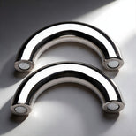 Two-piece stainless steel magnetic cock ring separated to show curved halves with secure magnetic closure system