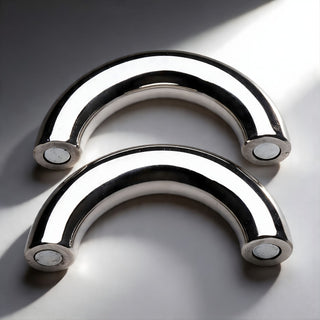 Two-piece stainless steel magnetic cock ring separated to show curved halves with secure magnetic closure system