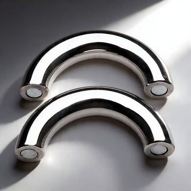 Two-piece stainless steel magnetic cock ring separated to show curved halves with secure magnetic closure system