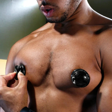 Nip Suckers 3.0 suction cup pinched onto one nipple beside a locked-on cup