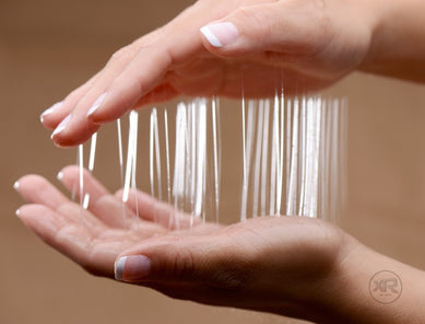 Clear nuru gel poured to show its slippery water-based texture