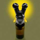 Pig Snout X dual-flow topper mounted on an amber essential oil bottle