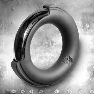 Pinch Zero silicone-cased chrome cock ring on a riveted steel background