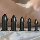 Rectal Dilator Training Kit featuring graduated black silicone anal plugs in multiple sizes arranged in a row for progressive training, smooth tapered design for comfort similar to Stockroom, Kink Store, and Bondesque styles
