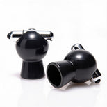 Two black vibrating nipple suckers displayed on a white background, featuring bulb-shaped suction chambers and silver vibrating tips