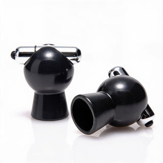 Two black vibrating nipple suckers displayed on a white background, featuring bulb-shaped suction chambers and silver vibrating tips