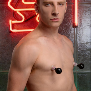Male model using transparent nipple suction cups with pump bulbs for increased sensitivity and arousal