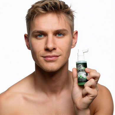 Male model holding Suck It Deep Throat Desensitizing Spray bottle to demonstrate product size and packaging