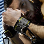 Tactical Wrist Cuff worn by a bearded model, black neoprene cuff with D-ring and carabiner