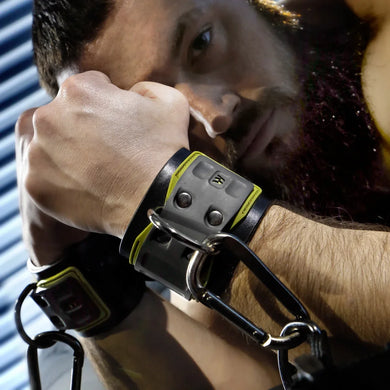 Tactical Wrist Cuff worn by a bearded model, black neoprene cuff with D-ring and carabiner