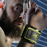 Tactical Wrist Cuffs clipped overhead, model with wrists bound above his head