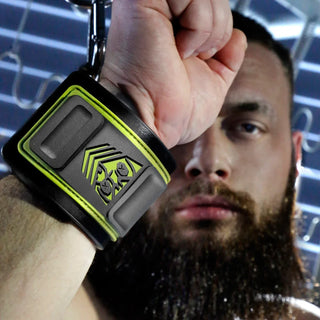 Tactical Wrist Cuff close-up on a raised fist showing the olive shield logo