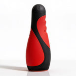 Vibra Head Bionic Auto Stroker standing upright with a red and black ergonomic exterior, textured grip contours, and compact hands-free design