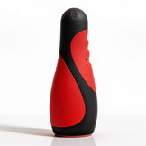 Vibra Head Bionic Auto Stroker standing upright with a red and black ergonomic exterior, textured grip contours, and compact hands-free design
